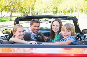 family in red convertible