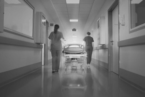 Patient in hospital hallway with nurses